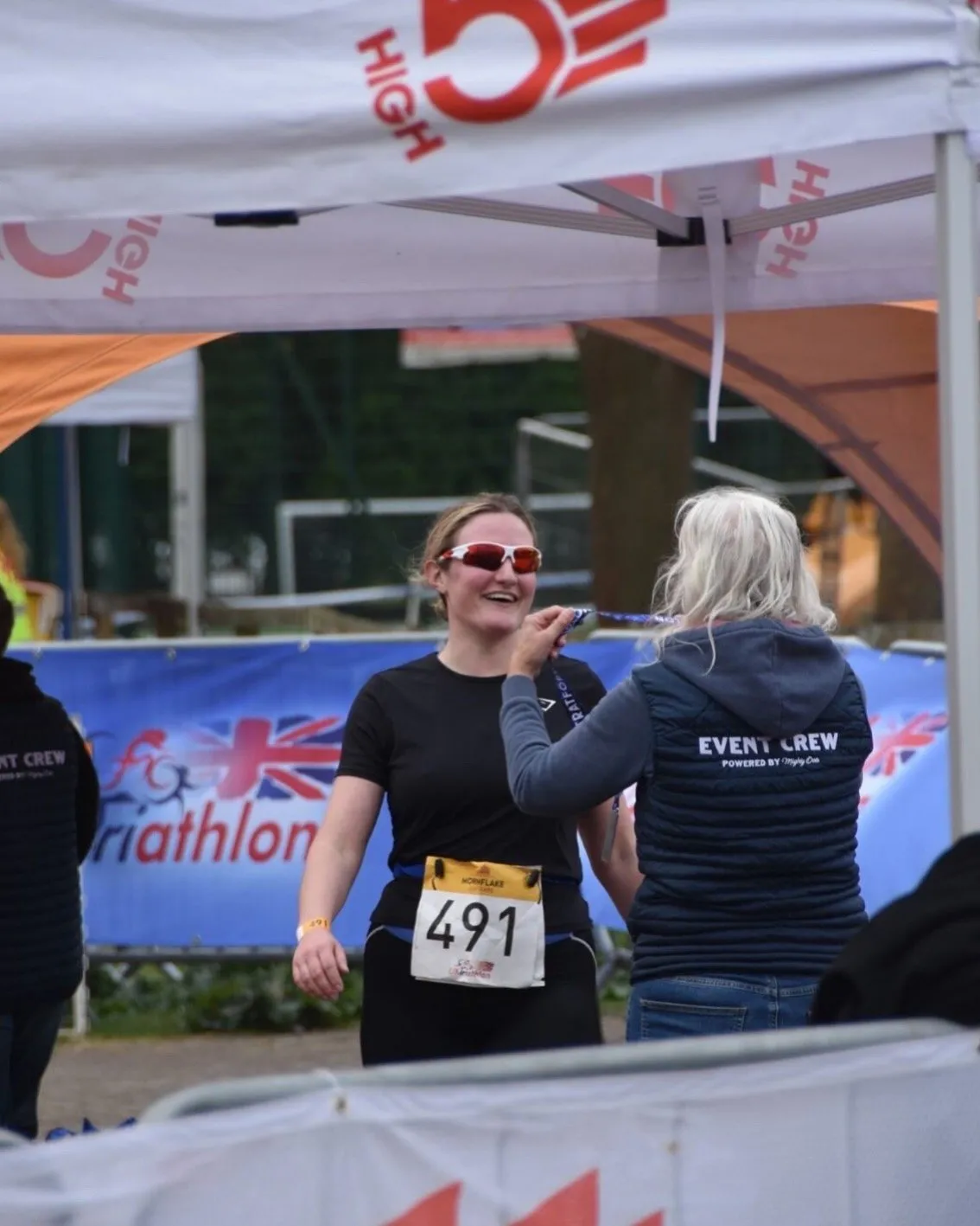 Emily supporting runners at a local sporting event